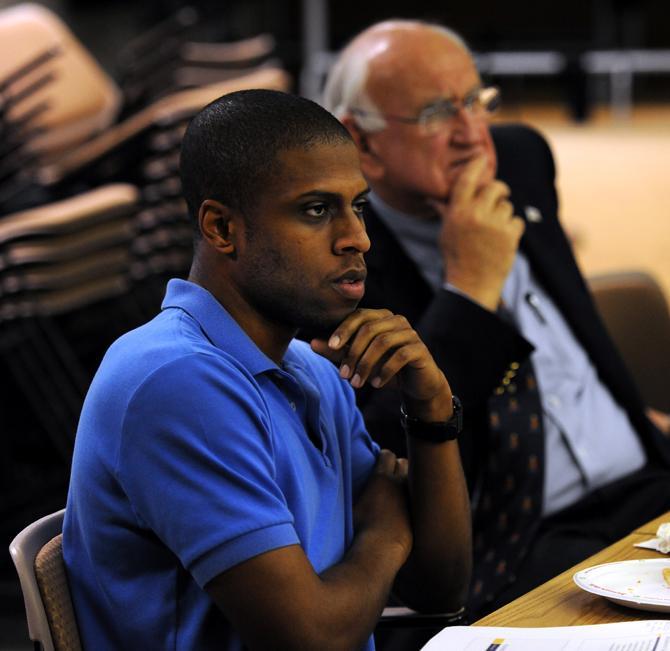 LSU bio-chemistry undergraduate Charles Lewis (left) and Interim Chancellor Dr. William "Bill" Jenkins (right) listen to the members share their views on the direction of academics for the transition Thursday, Feb. 28, 2013 at the Academic Subcommittee in Efferson Hall.
 