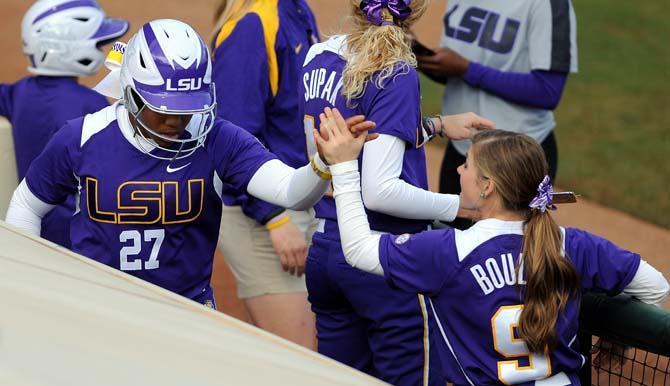 LSU freshman Bianka Bell (left) high fives teammate Alex Boulet (right) on Friday, Feb. 8, 2013 during the tiger's first game of the season against North Carolina at Tiger Park.
 