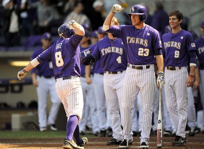 LSU senior infielder Mason Katz (8) and junior infielder JaCoby Jones (23) celebrate after a run from Katz during the Tigers' 13-1 victory against the Southeastern Lions Sunday Feb. 24, 2013 in Alex Box Stadium.
 