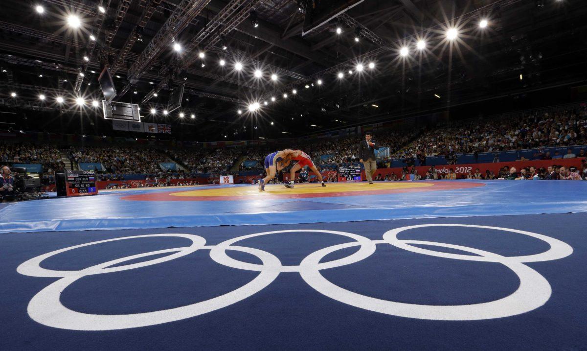 FILE - The Aug. 6, 2012 file photo shows Sayed Abdelmonem Hamed of Egypt competing against Zaur Kuramagomedov of Russia (in blue) during the 60-kg Greco-Roman wrestling competition at the 2012 Summer Olympics in London. IOC leaders have dropped wrestling for the 2020 Games in a surprise decision to scrap one of the oldest sports on the Olympic program. The IOC executive board decided Tuesday, Feb. 12, 1013 to retain modern pentathlon &#8212; the event considered most at risk &#8212; and remove wrestling instead from its list of core sports. (AP Photo/Paul Sancya)