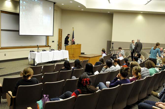 Students wait for the seminar to begin Friday, Feb. 15, 2013 in the Energy Coast and Environment building on campus.
 