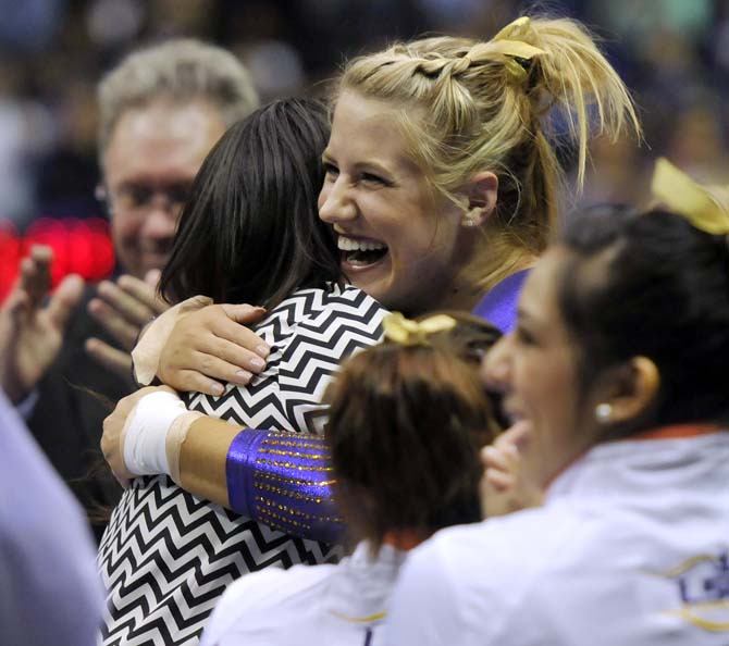 LSU junior all-around Sarie Morrison hugs volunteer coach Ashleigh Clare-Kearney on Friday, Feb. 15, 2013 during the Tiger's 196.825-195.625 win over the Arkansas Razorbacks in the PMAC.
 