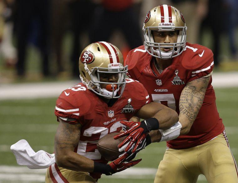 San Francisco 49ers quarterback Colin Kaepernick (7) hands off to running back LaMichael James (23) during the second half of the NFL Super Bowl XLVII football game against the Baltimore Ravens, Sunday, Feb. 3, 2013, in New Orleans. (AP Photo/Elaine Thompson)
 