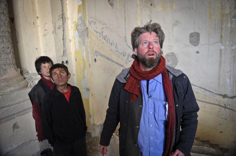 An undated production still photograph from the Oscar-nominated film, "Buzkashi Boys," which was filmed in Kabul, Afghanistan, shows actors Jawanmard Paiz, left, Fawad Mohammadi, center, and director Sam French at work on the set of the film. The actors were plucked from the dingy streets of the Afghan capital to be the main stars of &#8220;Buzkashi Boys,&#8221; a coming-of-age movie filmed entirely in a war zone and nominated in the Best Live Action Short Film category. The movie is about two penniless young boys _ a street urchin and a blacksmith&#8217;s son _ who are best friends and dream of becoming professional players of buzkashi, a brutal, polo-like game in which horseback riders wrangle to get a headless goat carcass into a circular goal at one end of the field. (AP Photo/David Gill, Afghan Film Project)
 