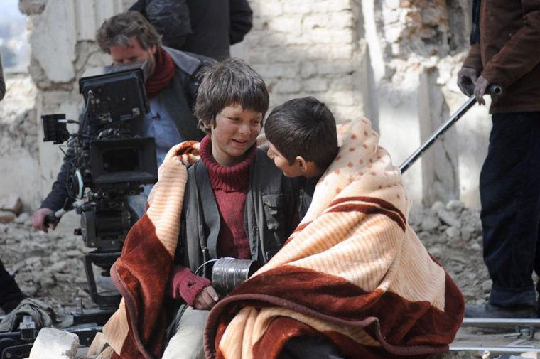 An undated production still photograph from the Oscar-nominated film, "Buzkashi Boys," which was filmed in Kabul, Afghanistan, shows actors Jawanmard Paiz, center, Fawad Mohammadi, right, and director Sam French at work on the set of the film. The actors were plucked from the dingy streets of the Afghan capital to be the main stars of &#8220;Buzkashi Boys,&#8221; a coming-of-age movie filmed entirely in a war zone and nominated in the Best Live Action Short Film category. (AP Photo/David Gill, Afghan Film Project)
 