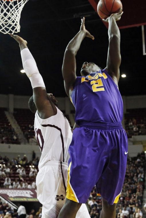 LSU forward Johnny O'Bryant III (2) leaps over the defense of Mississippi State forward Gavin Ware (20) to score a basket in the second half of an NCAA college basketball game in Starkville, Miss., Saturday, Feb. 2, 2013. LSU won 69-68. (AP Photo/Rogelio V. Solis)
 