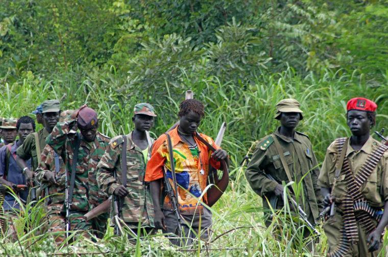 FILE - In this July 31, 2006 file photo, members of Uganda's Lord's Resistance Army (LRA) are seen as their leader Joseph Kony meets with a delegation of Ugandan officials and lawmakers and representatives from non-governmental organizations, in the Democratic Republic of Congo near the Sudanese border. The LRA Crisis Tracker group which tracks the Joseph Kony-led LRA said in a report released Thursday, Feb. 7, 2013 that the LRA killed 51 civilians across Central Africa in 2012, a huge drop in the number killed from two years previous. (AP Photo, File)
 