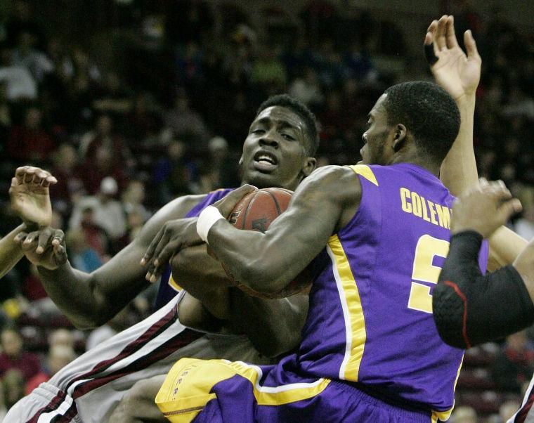 LSU's Johnny O'Bryant III, left, and Shavon Coleman (5) battle for the rebound during the first half of their NCAA college basketball game against South Carolina, Thursday, Feb. 14, 2013, in Columbia, S.C. (AP Photo/Mary Ann Chastian)
 