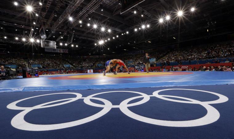 FILE - The Aug. 6, 2012 file photo shows Sayed Abdelmonem Hamed of Egypt competing against Zaur Kuramagomedov of Russia (in blue) during the 60-kg Greco-Roman wrestling competition at the 2012 Summer Olympics in London. IOC leaders have dropped wrestling for the 2020 Games in a surprise decision to scrap one of the oldest sports on the Olympic program. The IOC executive board decided Tuesday, Feb. 12, 1013 to retain modern pentathlon &#8212; the event considered most at risk &#8212; and remove wrestling instead from its list of core sports. (AP Photo/Paul Sancya)
 