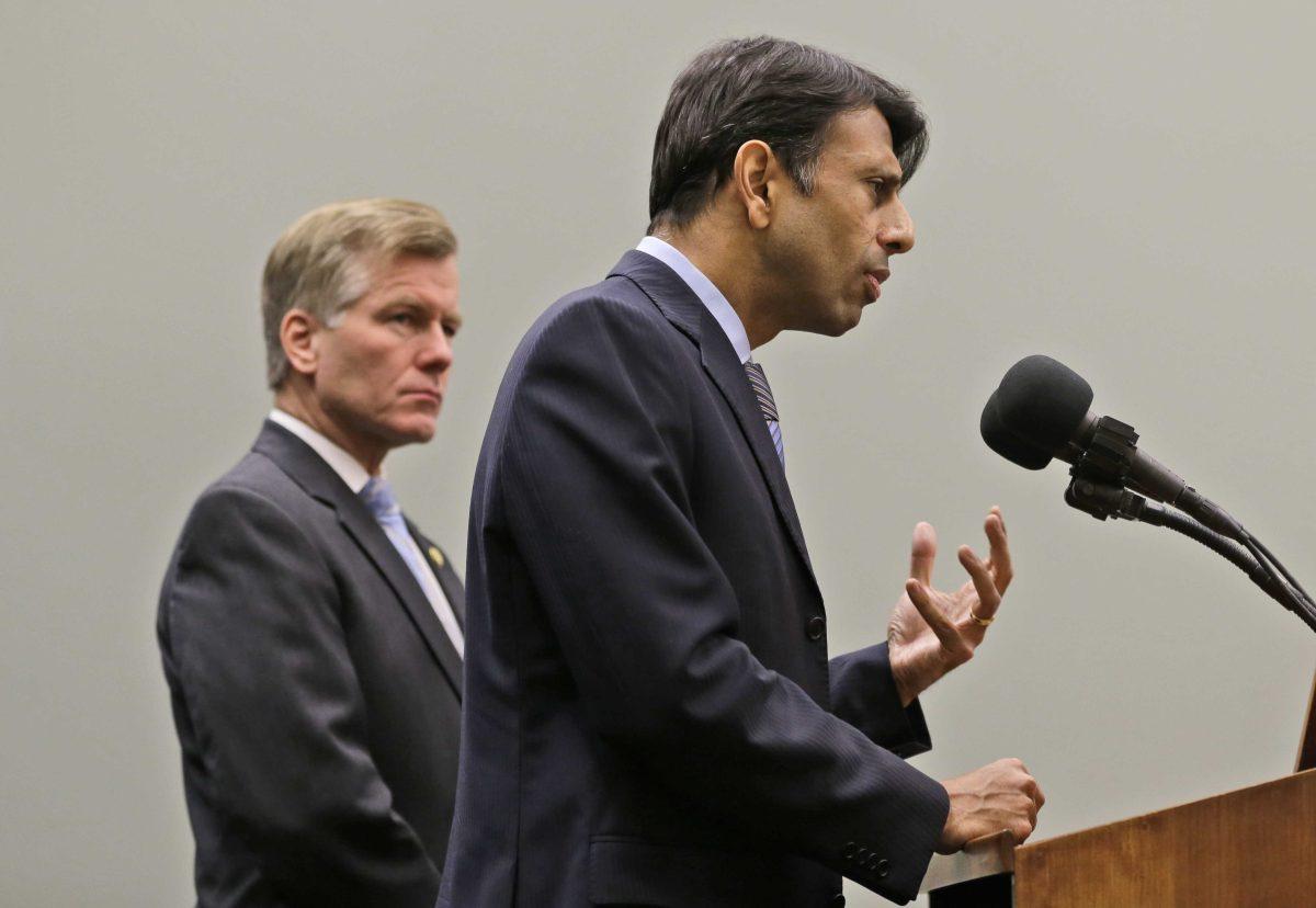 Louisiana Gov. Bobby Jindal, right, gestures as he and Virginia Gov. Bob McDonnell, left, address the press during a news conference Friday, Feb. 8, 2013 in Richmond, Va. The two governors discussed K-12 education reforms. (AP Photo/Steve Helber)