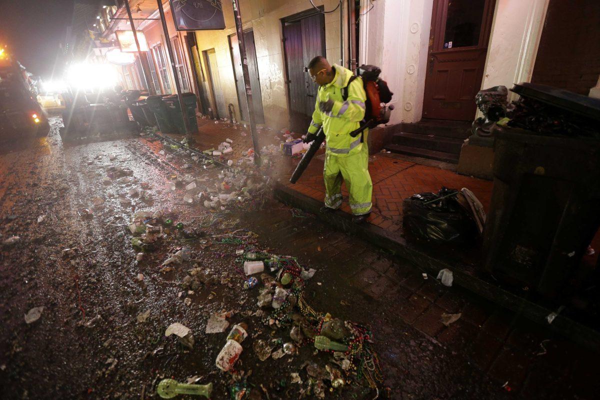 Workers clean up debris on Bourbon Street in the early morning of Ash Wednesday, the day after Mardi Gras, in the French Quarter of New Orleans, Wednesday, Feb. 13, 2013. The city has begun to clean up after Mardi Gras came to a close at midnight, with Ash Wednesday ushering in the solemn season of Lent. (AP Photo/Gerald Herbert)