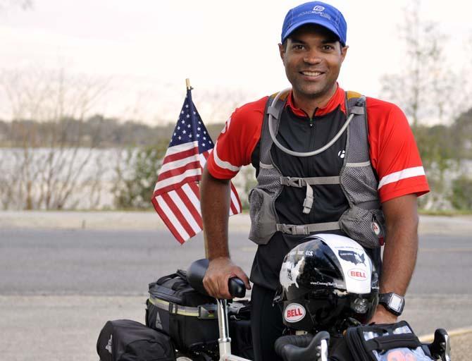 Chris Nicholas stands next to his bike Tuesday, Feb. 5, 2013. He is biking from Portland, Maine, to Portland, Oregon to raise money and awareness for St. Jude's Children's Research Hospital, Wounded Warrior Project, and Make a Wish foundation.
 