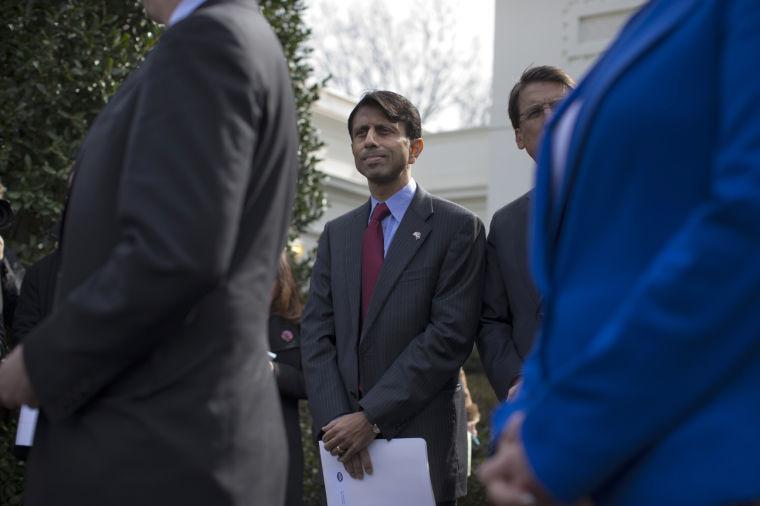 Louisiana Gov. Bobby Jindal listens as National Governors Association Chairman, Delaware Gov. Jack Markell, speaks with reporters outside the White House in Washington, Monday, Feb. 25, 2013, following their meeting with President Barack Obama. (AP Photo/Evan Vucci)
 