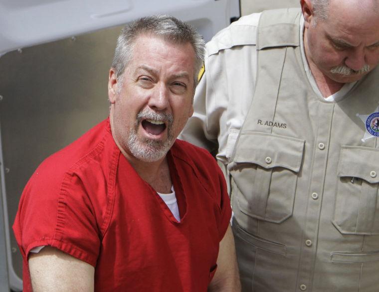 FILE - In this May 8, 2009 file photo, former Bolingbrook, Ill., police sergeant Drew Peterson arrives at the Will County Courthouse in Joliet, Ill., for his arraignment on charges of first-degree murder in the 2004 death of his third wife Kathleen Savio. On Thursday, Feb. 21, 2013, Will County Judge Edward Burmila sentenced Peterson to 38 years in prison for Savio's murder. (AP Photo/M. Spencer Green, File)
 