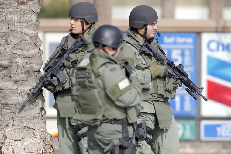 Corona, Calif., Police officers stand near the site of a police shooting Thursday Feb. 7, 2013 in Corona, Calif. Christopher Dorner is suspected of shooting two LAPD officers who were sent to Corona to protect someone Dorner threatened in a rambling online manifesto. Thousands of police officers throughout Southern California and Nevada searched for Dorner, a former Los Angeles officer who was angry over his firing and began a deadly shooting rampage that he warned in an online posting would target those on the force who wronged him. (AP Photo/Nick Ut)
 