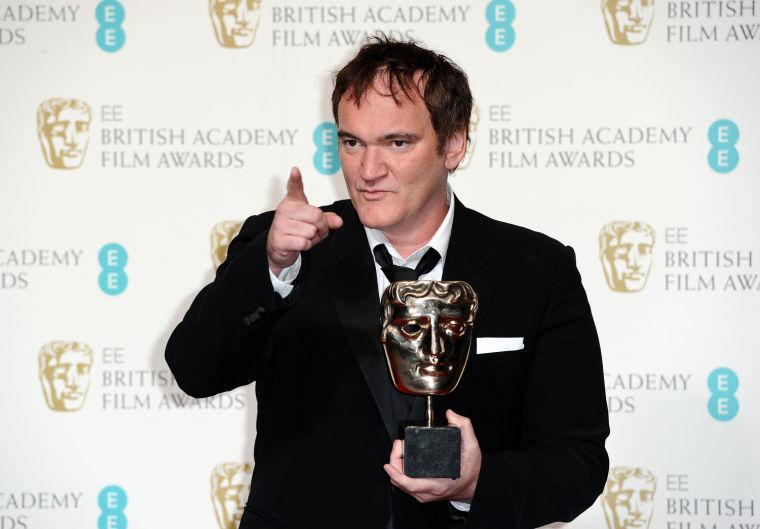 Writer-director Quentin Tarantino holds the award for best Original Screenplay for "Django Unchained," at the BAFTA Film Awards at the Royal Opera House on Sunday, Feb. 10, 2013, in London. (Photo by Jonathan Short/Invision/AP)
 