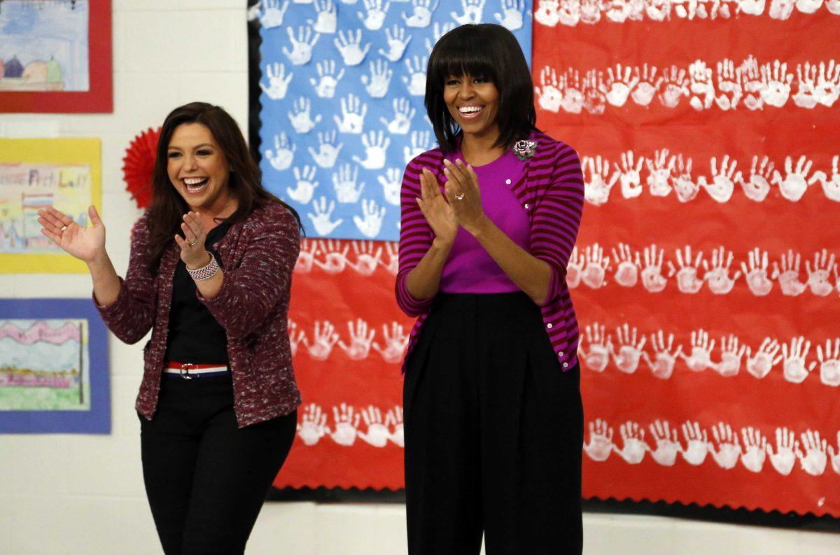 First lady Michelle Obama and Food Network chef Rachel Ray greet students at a "Let's Move!" program at the Eastside and Northside Elementary Schools in Clinton, Miss., Wednesday, Feb. 27, 2013. Obama and Ray visited with the children and conducted a cooking contest between the schools chefs. (AP Photo/Rogelio V. Solis)