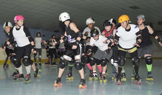 Blockers try to keep a jammers from passing the pack Tuesday, Feb. 19, 2013 in a Red Stick Roller Derby practice bout at Leo's Rollerland.
 