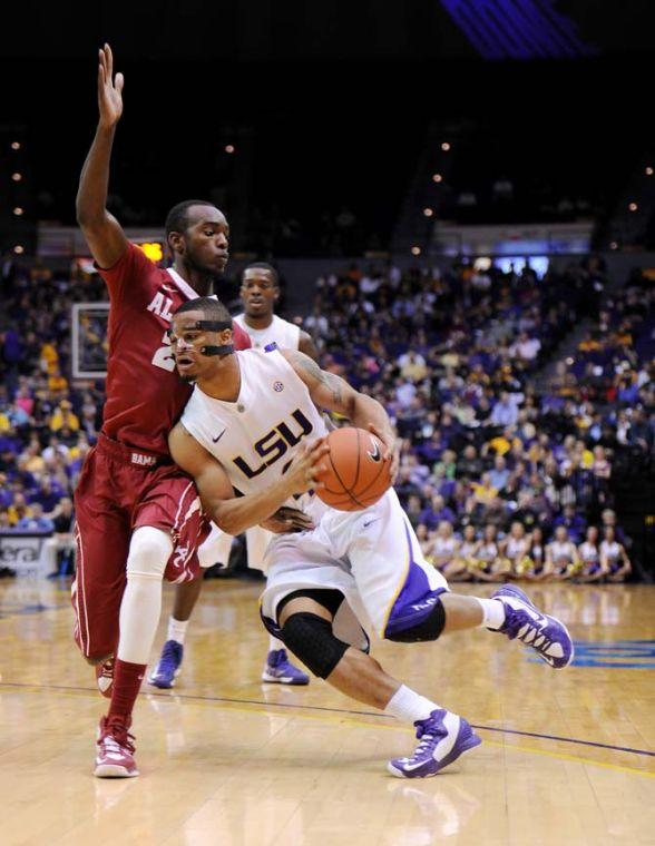 LSU freshman guard Corban Collins runs past Alabama freshman forward Devonta Pollard Saturday, Feb. 23, 2013 during the Tigers' 97-94&#160;triple overtime victory against the Crimson Tide.
 