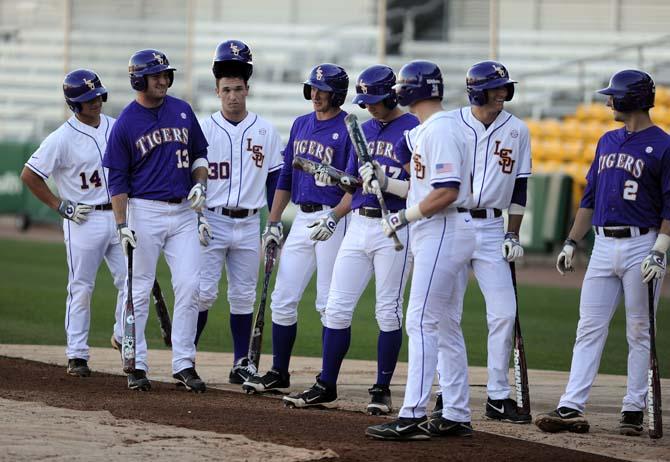 A group of baseball players wait in line to practice batting on Friday, Feb. 1, 2013 at Alex Box Stadium.
 