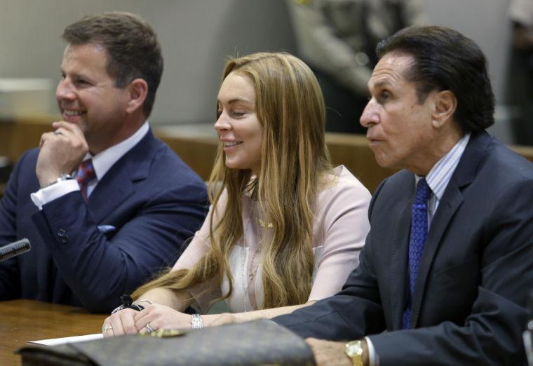 Actress Lindsay Lohan, and attorneys Mark Heller, right, and Anthony Falangetti appear at a hearing in Los Angeles Superior Court Monday, March 18, 2013. Lohan accepted a plea deal on Monday in a misdemeanor car crash case that includes 90 days in a rehabilitation facility. The actress, who has struggled for years with legal problems, pleaded no contest to reckless driving, lying to police and obstructing officers who were investigating the accident involving the actress in June. (AP Photo/Reed Saxon, Pool)
 