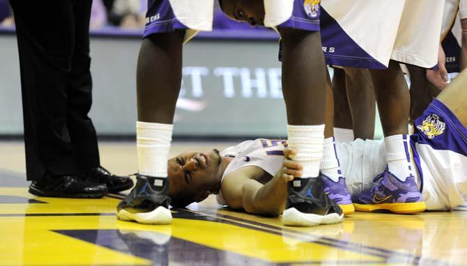 LSU senior guard Charles Carmouche (0) grimaces March 9, 2013 after getting injured in the first half of the Tiger's 67-81 loss to Ole Miss in the PMAC.
 