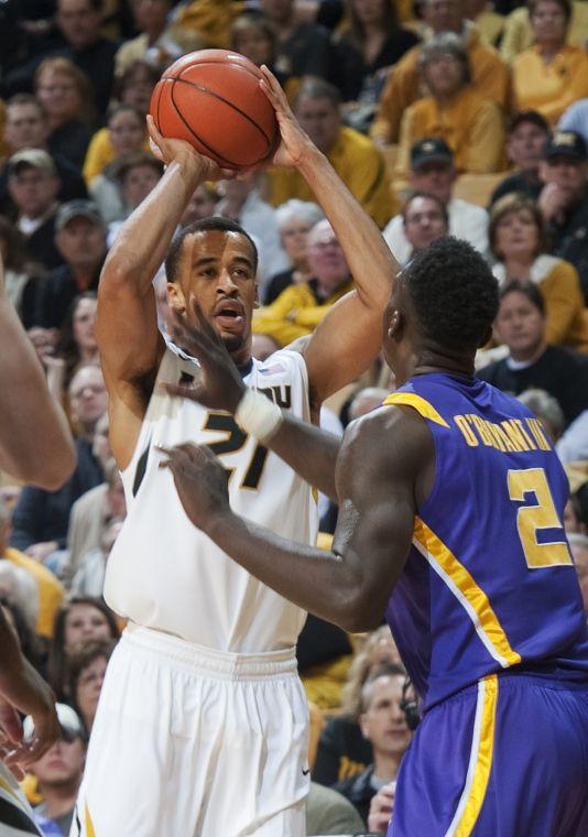 Missouri's Laurence Bowers, left, shoots a 3-point shot over LSU's Johnny O'Bryant III, right, during the first half of an NCAA college basketball game Saturday, March 2, 2013, in Columbia, Mo. Bowers led all scorers with 23 points in Missouri's 89-76 victory. (AP Photo/L.G. Patterson)
 