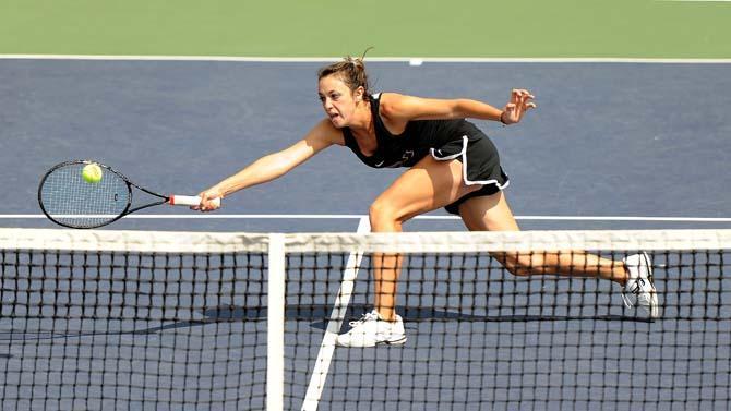 LSU senior Kaitlin Burns dives to hit the ball Sunday, March 17, 2013 during a doubles match against Missouri at W.T. "Dub" Robinson Tennis Stadium.
 