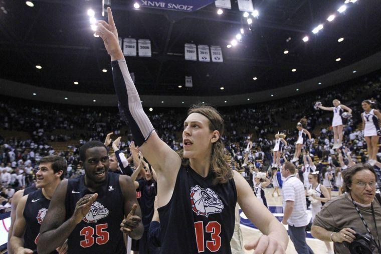 Gonzaga's Kelly Olynyk (13) and teammate Sam Dower (35) celebrate their 70-65 victory over Brigham Young during their NCAA basketball college game Thursday, Feb. 28, 2013, in Provo, Utah. (AP Photo/Rick Bowmer)
 