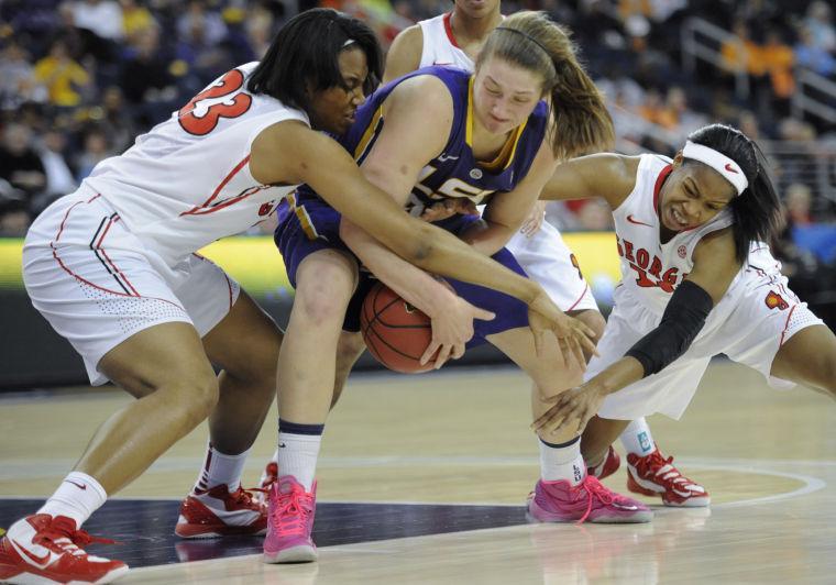 LSU forward Theresa Plaisance, center, is pressured by Georgia forward Tamika Willis, left, and guard Jasmine James, right, during the second half of an NCAA college basketball game in the Southeastern Conference tournament on Friday, March 8, 2013, in Duluth, Ga. Georgia won 71-53. (AP Photo/John Amis)
 