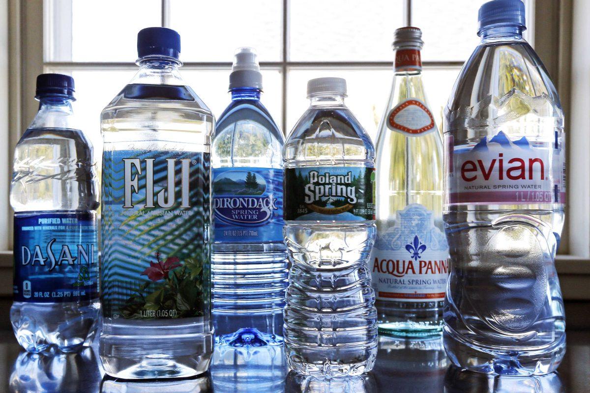 In this Tuesday, March 5, 2013 photo, a selection of bottled waters stands on a kitchen counter in East Derry, N.H. Soda's reign as America's most popular drink could be entering its twilight years, with plain old bottled water making a run for the top spot. Already, bottled water has surged past juice, milk and beer in terms of per capita consumption. The result is that bottled water is slowly closing the gap for the No. 1 spot. (AP Photo/Charles Krupa)