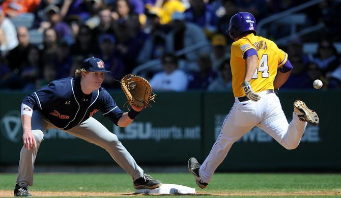 LSU junior third baseman Christian Ibarra (14) beats the throw to first Sunday, March 24, 2013 during the 8-2 victory against Auburn at Alex Box Stadium.
 