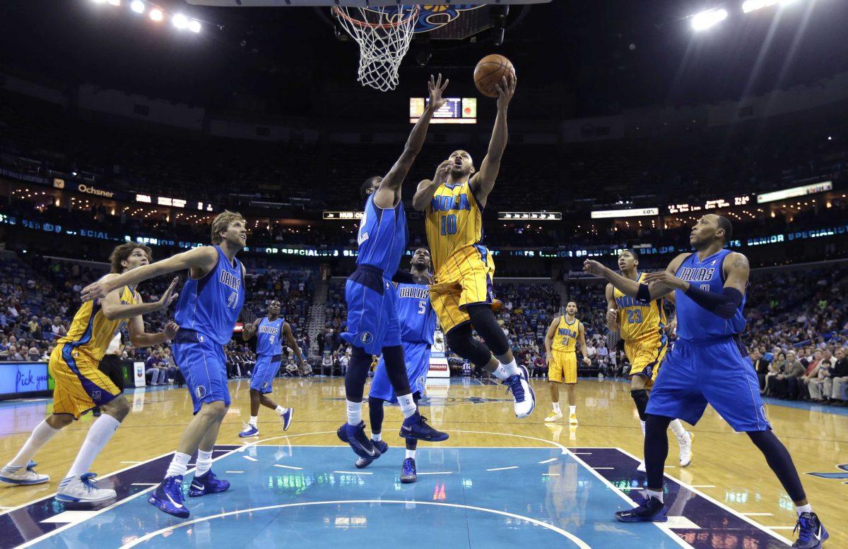 New Orleans Hornets guard Eric Gordon (10) drives to the basket against Dallas Mavericks' O.J. Mayo (32) in the first half of an NBA basketball game in New Orleans, Friday, Feb. 22, 2013. (AP Photo/Gerald Herbert)