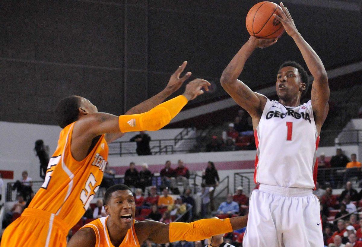 Georgia guard Kentavious Caldwell-Pope (1) shoots a 3-point basket while defended by Tennessee guards Jordan McRae (52) and guard Josh Richardson (1) during the first half of an NCAA college basketball game in Athens, Ga., Saturday, March 2, 2013. (AP Photo/The Athens Banner-Herald, AJ Reynolds)