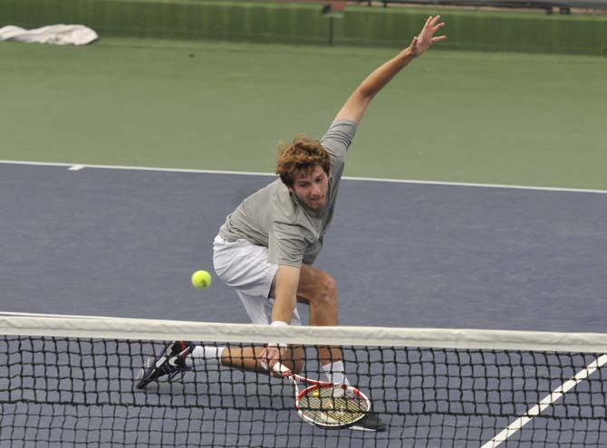 LSU senior Roger Anderson hits the ball Sunday, March 17, 2013, during a doubles match against Michigan in W.T. "Dub" Robinson Stadium.
 