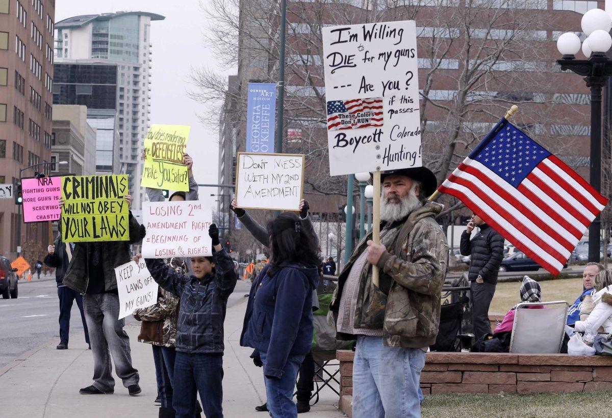 Protesters gather in front of the Capitol in Denver where State Senators are debating seven control bills on Friday, March 8, 2013. Colorado Democrats are on the cusp of passing gun control proposals in a state balancing a history of heartbreaking shootings with a Western heritage where gun ownership is treasured by many. (AP Photo/Ed Andrieski)