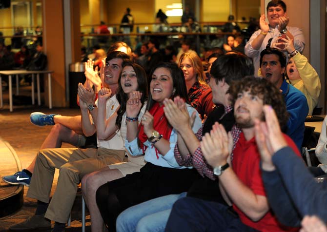 John Woodard, Taylor Parks, and supporters react to election results Tuesday, March 26, 2013.
 