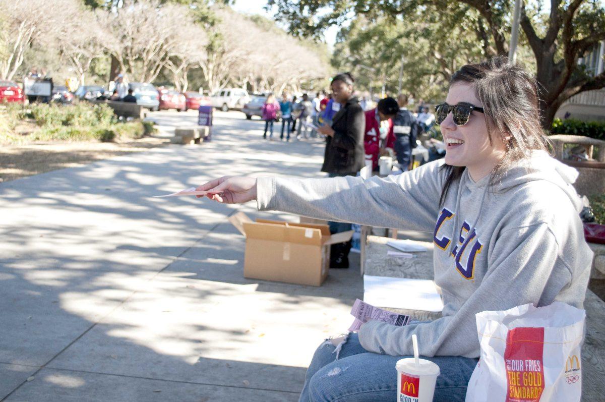 Tiffany Michel, Communication Studies sophomore, hands out fliers for Open Mic Night in Free Speech Alley.