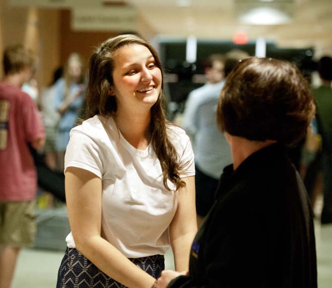 Newly reinstated Student Government Vice President Taylor Parks smiles as a supporter congratulates her on the UCourt's decision Sunday, March 7, 2013.
 