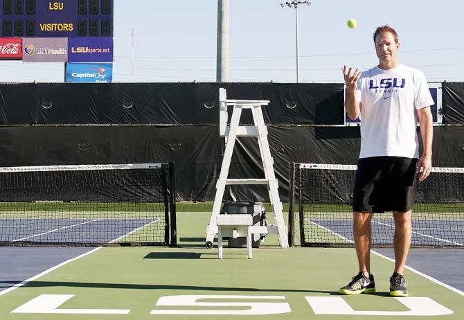 LSU men's tennis head coach Jeff Brown tosses a tennis ball Tuesday, March 19, 2013 in W.T. "DUB" Robinson Stadium.