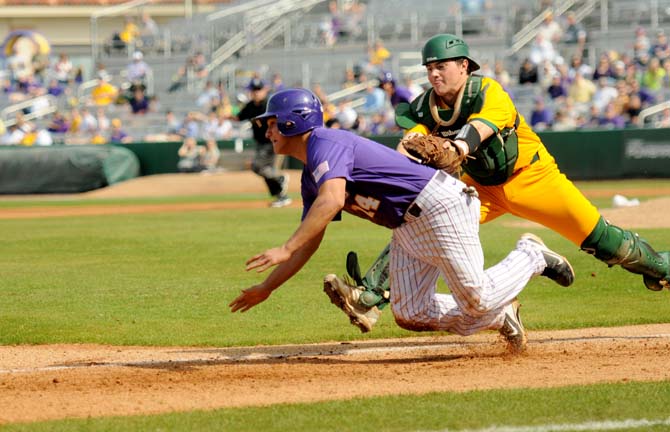 LSU sophomore pitcher Cody Glenn (24) slides to avoid a tag-out from a Southeastern catcher Sunday Feb. 24, 2013 during the Tigers' 13-1 victory against the Lions in Alex Box Stadium.