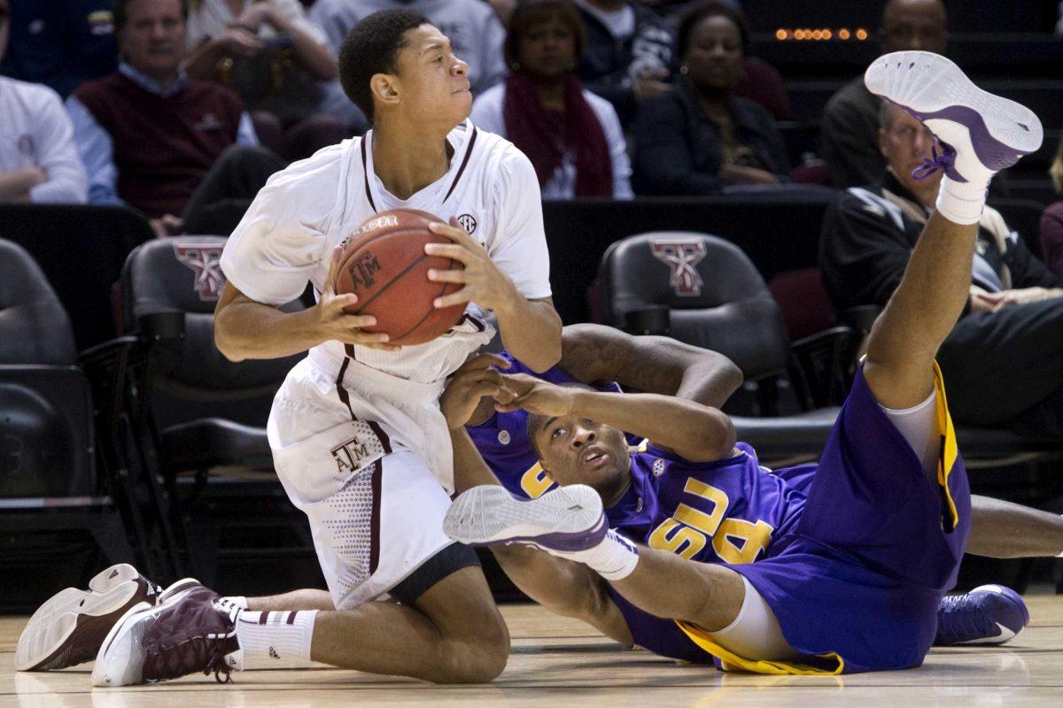 Texas A&amp;M's Jordan Green comes up with the ball against LSU's Corban Collins during the second half of an NCAA college basketball game in College Station, Texas on Wednesday, March 6, 2013. (AP Photo/Bryan-College Station Eagle, Stuart Villanueva)