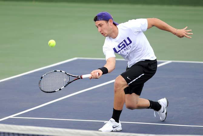 LSU senior Olivier Borsos returns the tennis ball Friday, March 22, 2013 during the Tigers' doubles match against the Ole Miss Rebels in W.T "Dub" Robinson Stadium.
 