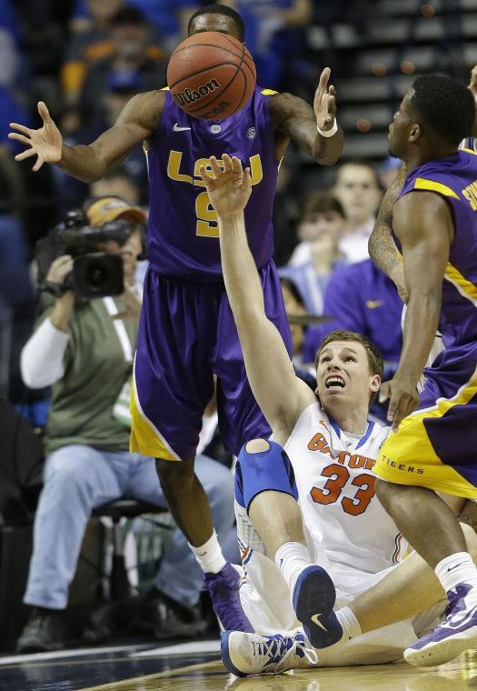 Florida forward/center Erik Murphy (33) vies for a loose ball with LSU guard Andre Stringer, right and LSU forward Johnny O'Bryant III (2) during the first half of an NCAA college basketball game at the Southeastern Conference tournament, Friday, March 15, 2013, in Nashville, Tenn. (AP Photo/John Bazemore)
 