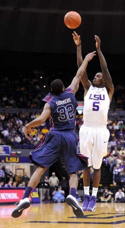 LSU junior forward Shavon Coleman (5) shoots over Ole Miss sophomore guard Jarvis Summers (32) during the Tigers' 67-81 loss to the Rebels in the PMAC.
 