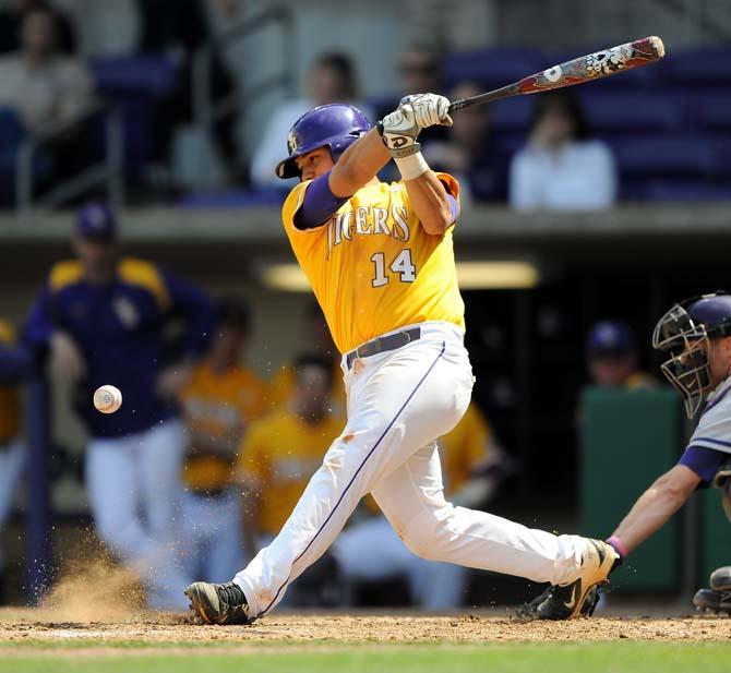 LSU junior infielder Christian Ibarra (14) swings at the ball Sunday, March 10, 2013 during the Tigers' 7-5 victory against the Washington Huskies in Alex Box Stadium.
 