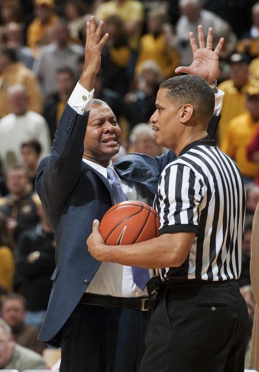 LSU head coach Johnny Jones, left, tries to make his case for a called foul to a referee during the first half of an NCAA college basketball game against Missouri Saturday, March 2, 2013, in Columbia, Mo. Missouri won the game 89-76. (AP Photo/L.G. Patterson)
 