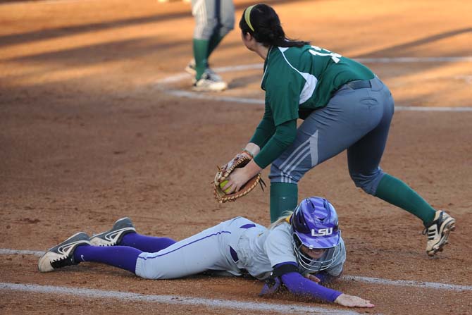 LSU junior utility Jacee Blades (23) slides to dodge being tagged Tuesday, March 26, 2013 during the Tigers' game against Southern University at Tiger Park. Blades stood up and slid into home.
 