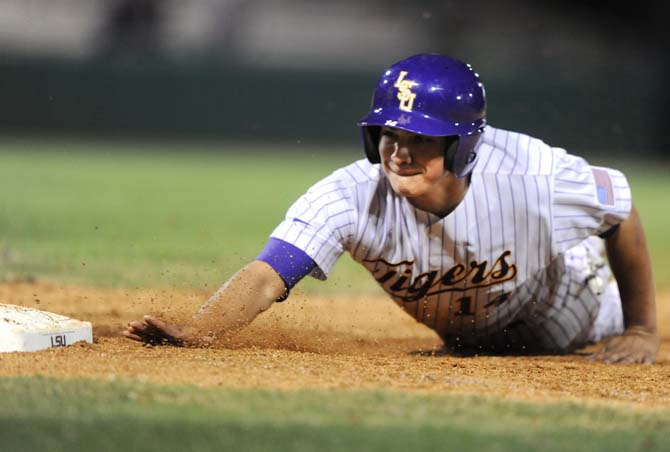 LSU junior infielder Christian Ibarra slides into first base March 20, 2013, during the Tigers' 2-1 victory against Northwestern State University at Alex Box Stadium.
 