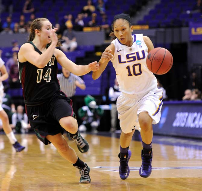 LSU senior guard Adrienne Webb (10) moves the ball past Green Bay sophomore guard Megan Lukan (14) Sunday, March 24, 2013 during the Tigers' 75-71 victory against Phoenix.
 